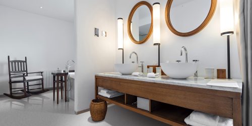 Modern bathroom interior with subtle lighting and circular mirrors